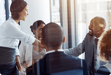 Team members greeting each other in corporate setting